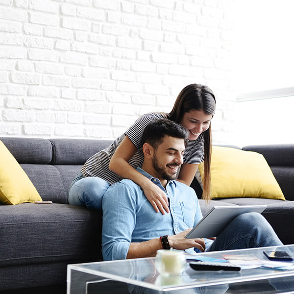 young couple sitting on couch